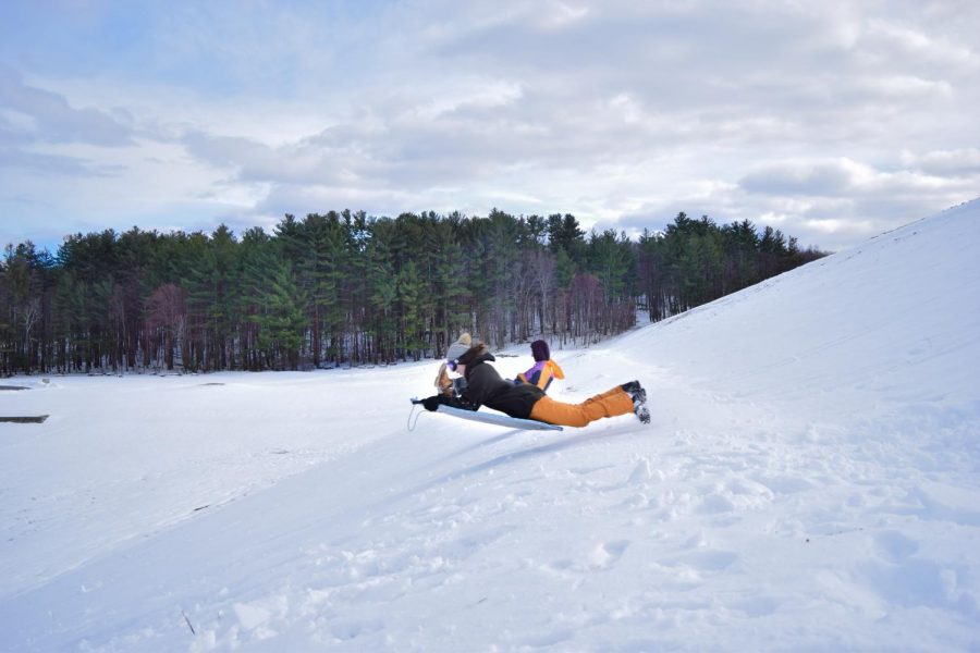 Photo: Jonathan Goldberg and Abby Brown take to the skies as they sled down the Hopkinton State Park dam.