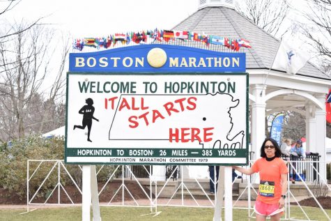 Photo: Denise Antaki standing in front of the "It All Starts Here Sign" two days before Marathon Monday.