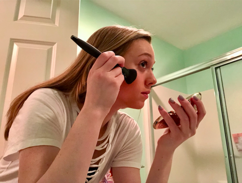 Photo: Caroline Murphy is applying makeup to her face