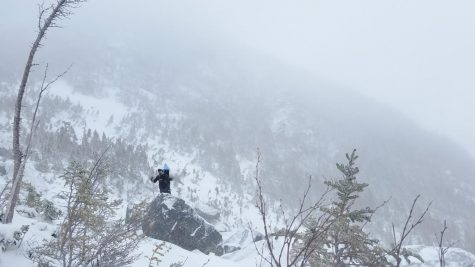 Photo: Lu Wang scaling a rock in the blizzard.
