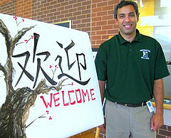 Mr. Ashoke Ghosh, Hopkinton High Schools new Vice Principal, stands in front of the welcome sign that was painted in honor of the HHSs new Chinese Culture and Mandarin language classes, taught by exchange teacher Ms. Jiling Pan from Jiang Xi, China.