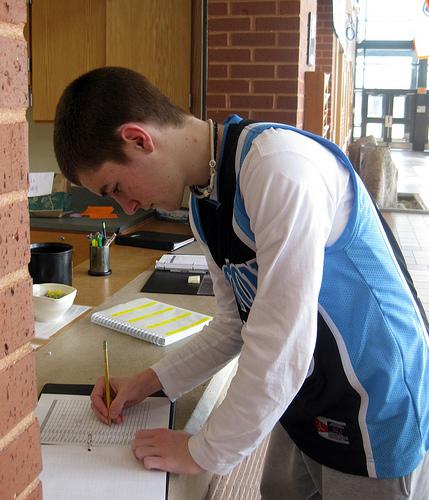 Senior Brendan Litavis signs out of school during one of his free periods.  Photo by Meghan Fleming