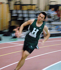 Senior, Josh Hacunda, races to hand the baton off to the next runner to complete the 4x400 relay in 3:51:8.  By: Hannah Krueger
