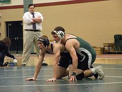 Given the advantage, Hopkintons Tucker Mayo (green) prepares to continue his fight verse his AMSA opponent. Mayo went on to win with a pin in the second round.  Photo by Evan Dackowski.