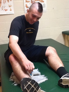 Senior lineman Connor Sullivan ices his ankle in preparation for practice. Photo by Lexie Papadellis