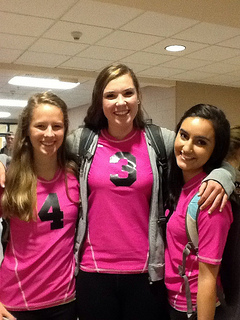 Seniors Kristen Cooprider, Tess Chandler, and Jillian Katz wear pink jerseys to support breast cancer during the Dig Pink volleyball match  on October 17th. photo by Samantha Sullivan