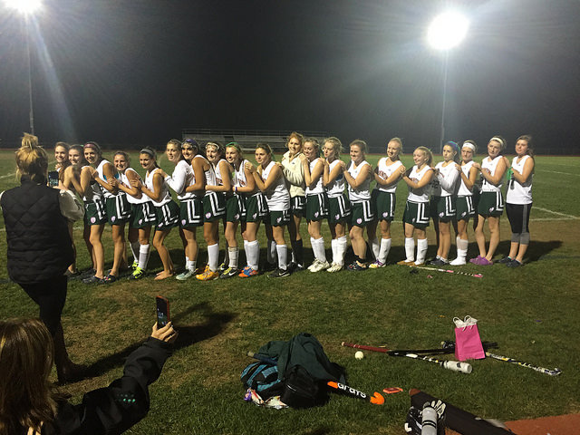 Field hockey lines up after the game to celebrate the tie and acceptance into tournament. Photo by Casey Palmer.