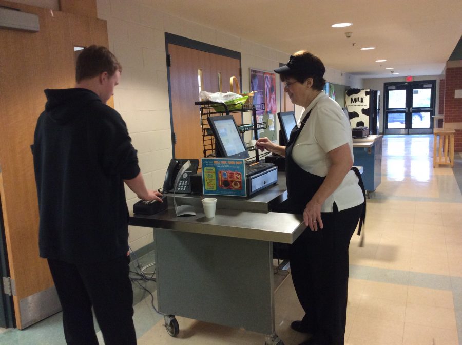 Kathy Bieri helps a student buy hot chocolate, one of many items available for purchase during the breakfast period.
