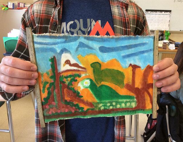 Joe Lanen shows his souvenir painting that he brought back from the Belize trip in Spanish class. Photo by Josh Normandeau.