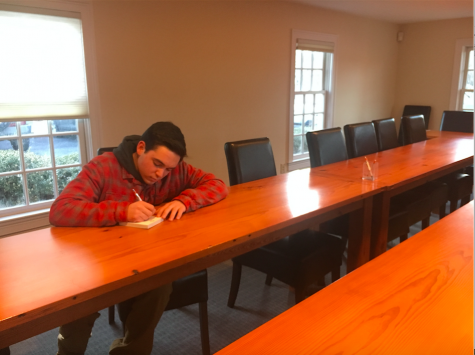 Photo: Patrick Murphy taking notes at a conference table