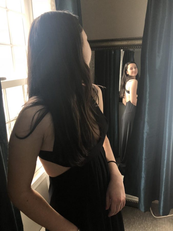 Photo: Tess Papagni is in her prom dress looking at herself in the mirror.