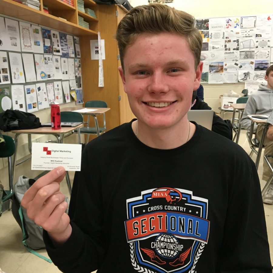Will Huebner holding his business card