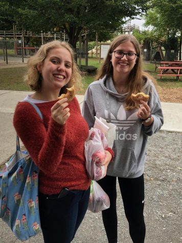 Photo: Karolina Ruessman (right) enjoys an apple cider donut on an Ambassadors Club outing.