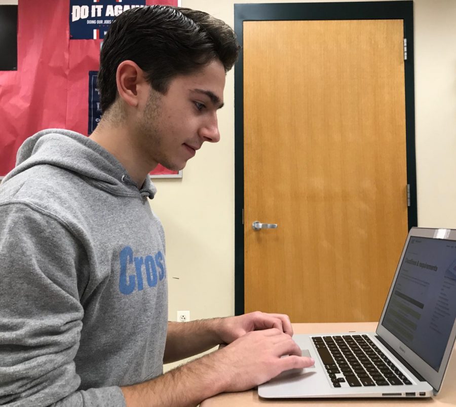 Senior Alex Matsoukas views the MIT admissions website as he prepares his application for Early Action.