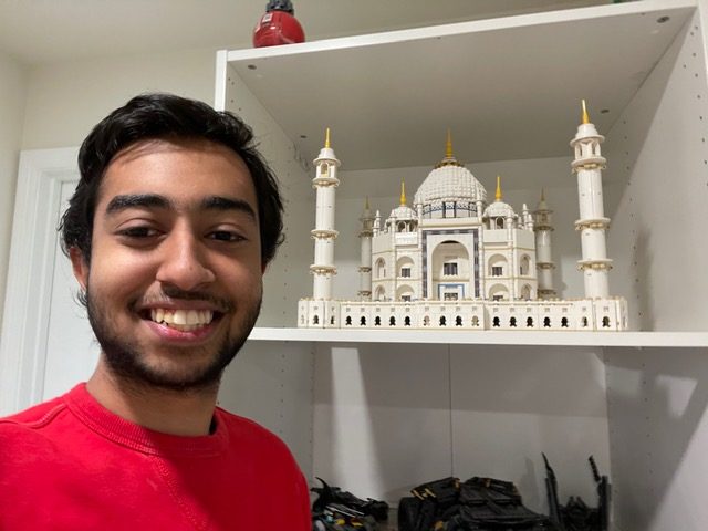 Inside his bedroom, Devansh stands next to his impressive LEGO constructions. His largest LEGO set, the Taj Mahal, took him almost 6 hours to build. 