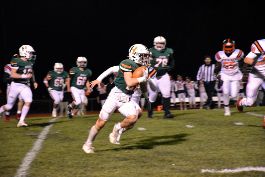 Photo: Running back Joey Carazza rushes forward on Friday night