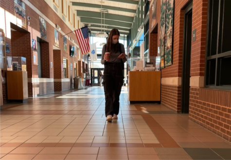 Senior Carly Ozmun walks to class sporting a Starbucks coffee after a study period. She is one of the many students on this Monday morning, 11/8, seen with her coffee 