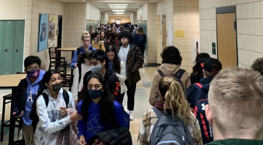Photo: Students move through halls with and without masks.