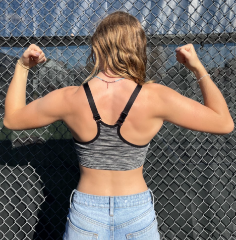 DiNicola showing off her defined muscles in front of the HHS tennis courts 