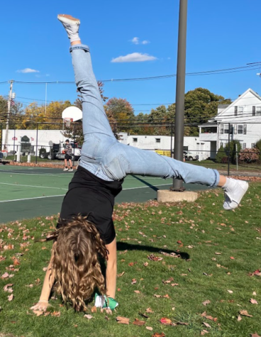 DiNicola is showing off her cartwheel at the basketball courts