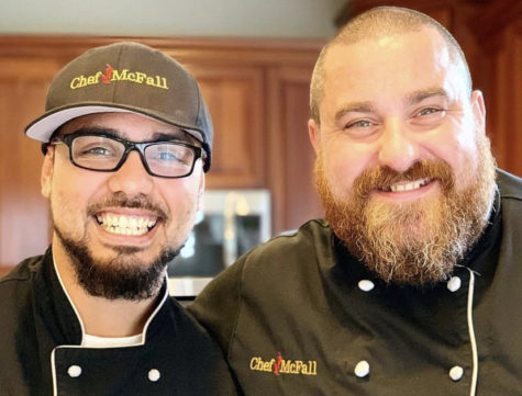 Chef Perez (left) and Chef McFall (right) pose for a photo in Chef McFall’s home kitchen as they wait for a customer to arrive to pick up their meals