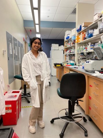 Sahithi Pogula stands beside her research lab bench as she has been working on liver cancer using epigenomics.