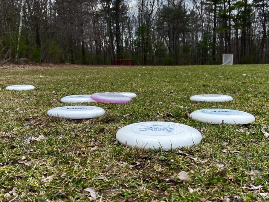 One+disc+at+a+time.+Hopkinton+High+schools+ultimate+frisbee+team+lays+their+disc+in+the+grass+as+they+warm+up.+Their+season+began+in+the+first+week+of+April.+We+got+a+lot+of+new+members+this+year%2C+we%E2%80%99ll+see+how+those+new+members+turn+out.%E2%80%9D+said+Coach+Mason+Challinor%2C+a+history+teacher+at+HHS.+Photo+by+Sanidi+Waduthanthri.+