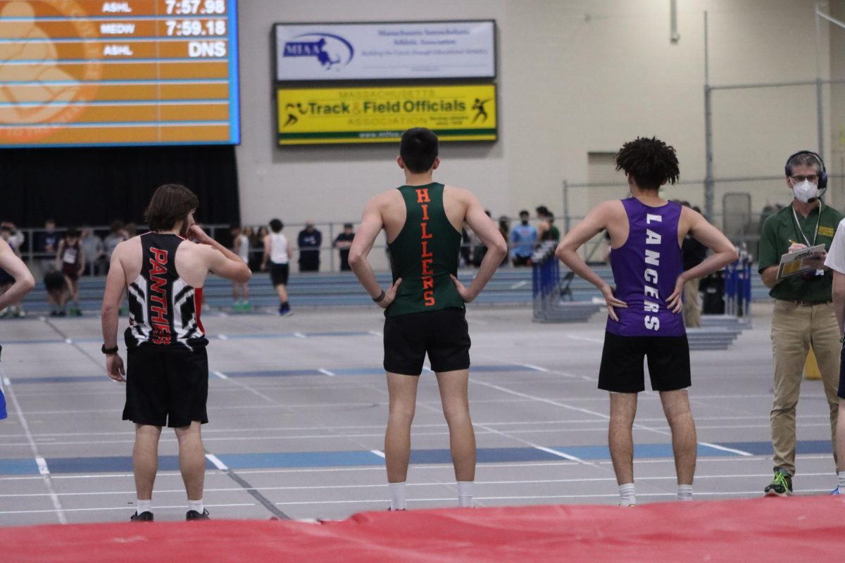 Cho catches his breath at the finish line after running a personal record in the 55m dash.