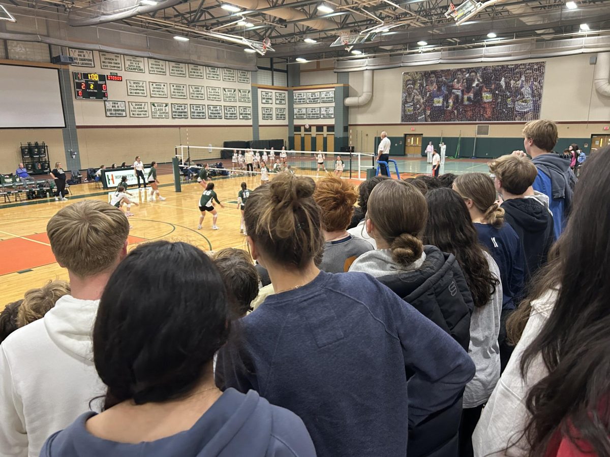 Fans eagerly watching the girls varsity volleyball team play Westwood in the Elite 8 game. The student section was full and only sat twice during timeouts. 