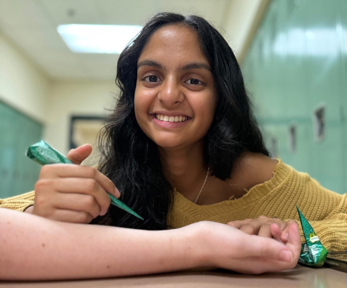 Maanya Shettigar practices henna on a friend in preparation for her next event. 