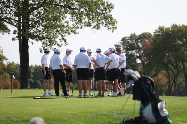 Head coach Bill Phaneuf gives the team pointers on their next round at Hopkinton Country Club.
