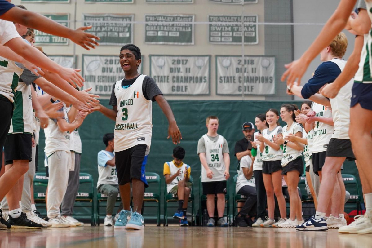 Unified athlete Sriram Kondeveti greets his teammates as caoch Chip Collins announces the starting lineup. The Hillers toppled their local rivals the Ashland Clockers. “It’s something that could be the best of hour of your day, When they see a full gym cheering for them, it’s like it’s their NBA finals,” Coach Chip Collins said.