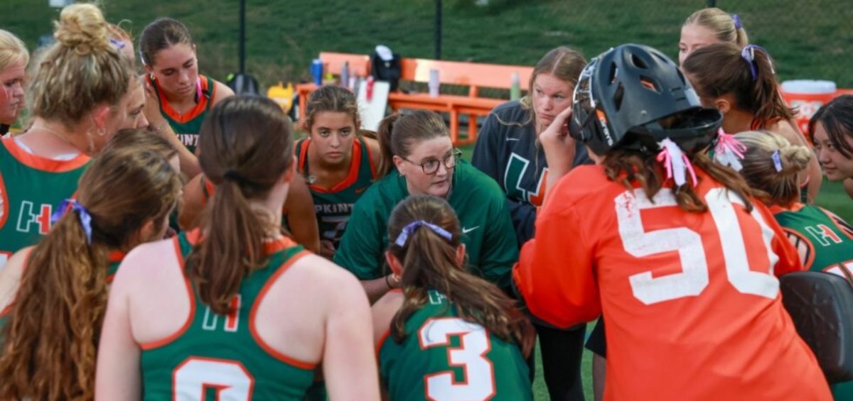 Head Coach Ally Valencia gives instructions in a team huddle at practice. The Hillers advanced to the round of eight in the MIAA postseason, after beating both Brookline and Concord-Carlisle. They face Waltham and Franklin next.
