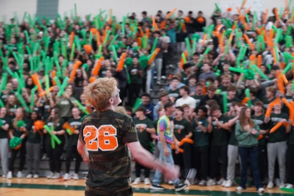 Ryan Click hypes up the crowd at the 2025 Pep Rally while students cheer in front of him. 