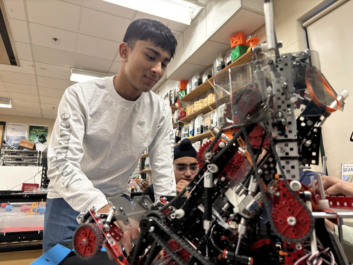 Pranav Raja and Agam Bhatia working together to prepare their robot for the most recent tournament. 