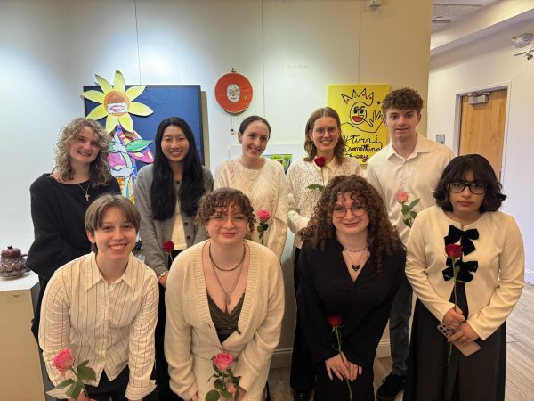 Featured students posing in front of their work during the closing ceremony.
