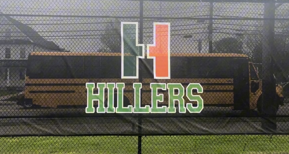 Arriving back on campus in the afternoon, a Hopkinton High School bus appears behind the hiller logo.